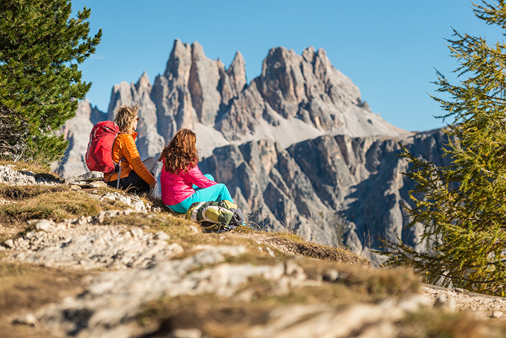 Two hikers view the Dolomites