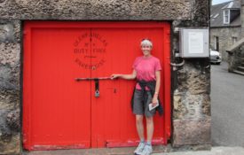 The red door of the Glenfarclas distillery warehouse during a small group tour of Scotland