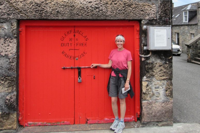 The red door of the Glenfarclas distillery warehouse during a small group tour of Scotland