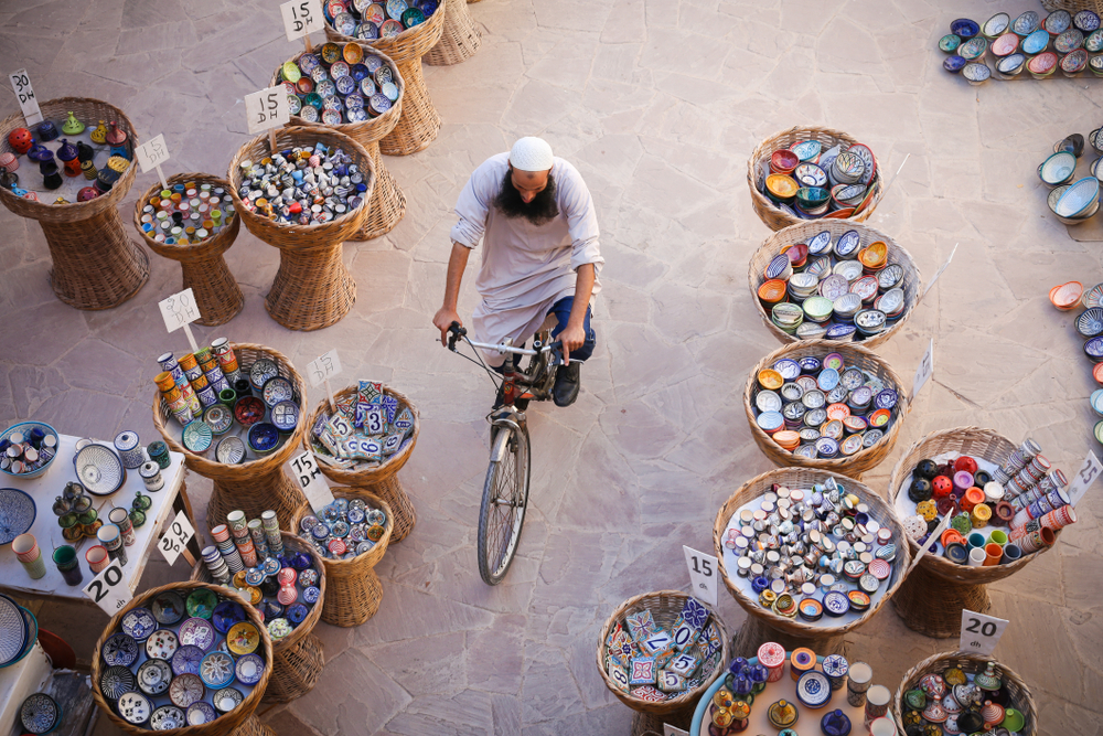 man riding bike in Moroccan market Essaouira