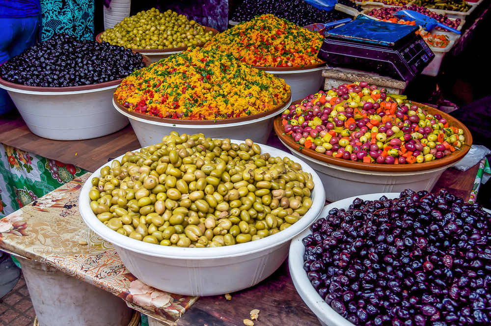 Bowls of colorful olives in a Moroccan market 