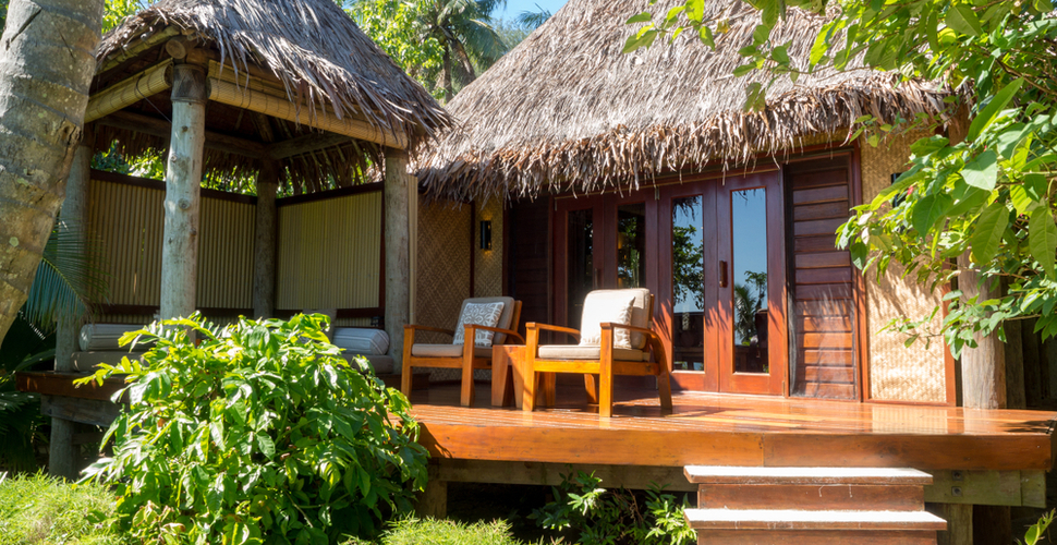 Chairs in the sun on the deck of a guest bure in Fiji