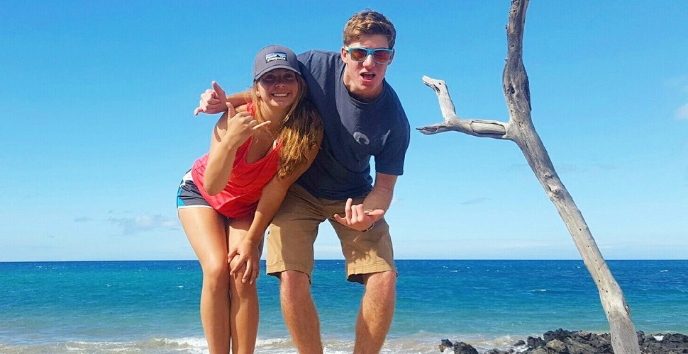 Brother and sister ham it up on the beach in Hawaii