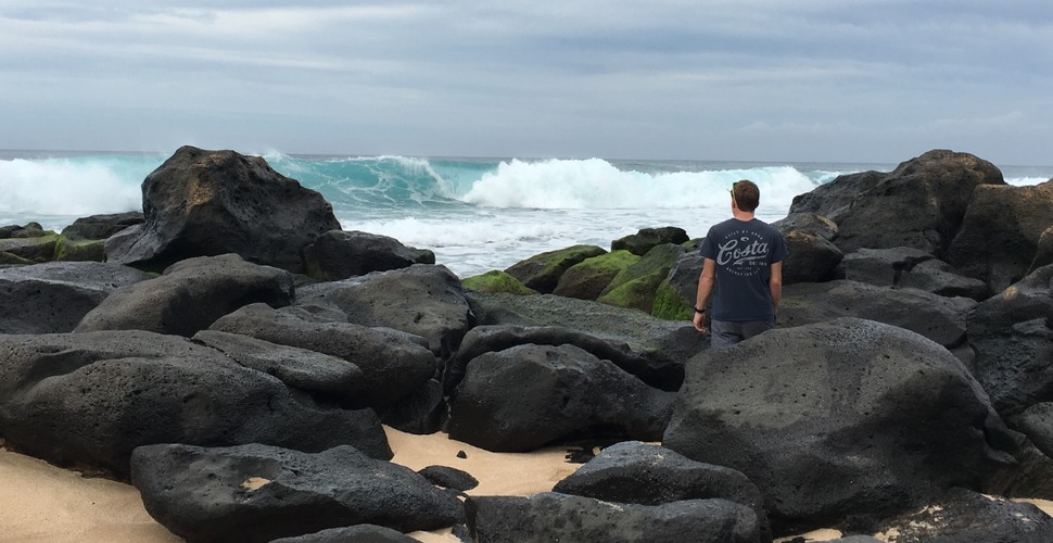 Looking out over the ocean from black rocks in Hawaii