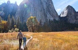 Father and son walk in Yosemite National Park on a Fall Day
