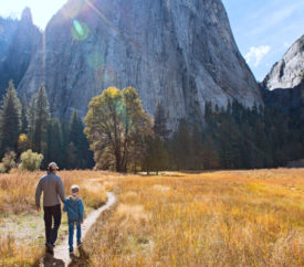 Father and son walk in Yosemite National Park on a Fall Day