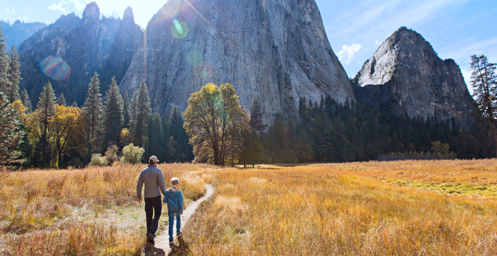 Father and son walk in Yosemite National Park on a Fall Day