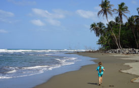 A little girl explores a Costa Rican beach