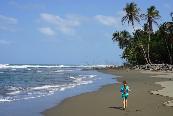 A little girl explores a Costa Rican beach