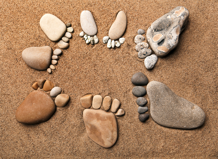 A circle of feet made of beach stones