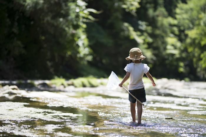 Young Girl Playing in River