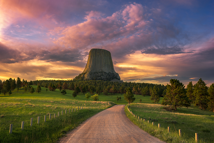 Devils Tower looms above a beautiful green landscape