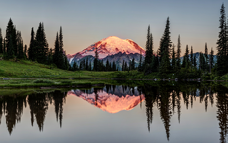 Mt. Rainier in Washington at dusk is mirrored in a lake