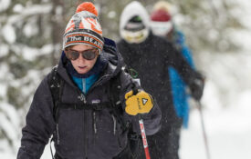 woman leading a group Cross-country skiing the trails around Old Faithful in Yellowstone National Park