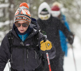 woman leading a group Cross-country skiing the trails around Old Faithful in Yellowstone National Park