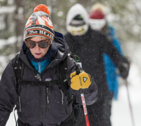 woman leading a group Cross-country skiing the trails around Old Faithful in Yellowstone National Park