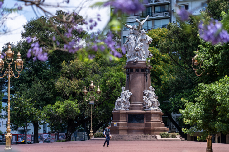 Blue jacaranda blossoms frame a plaza in Buenos Aires.