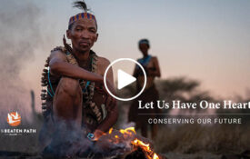 man sitting at fire talking about culture during an off the beaten path safari in botswana