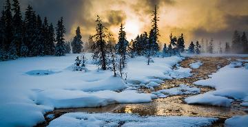 sunset over a steamy snowy river in yellowstone