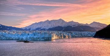 colorful sunset with a glacier and mountains in glacier bay national park