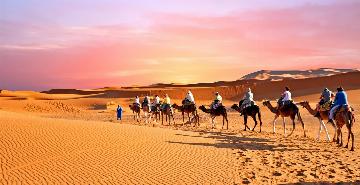 walking through the Sahara desert sand dunes in Morocco