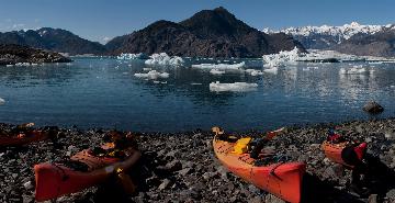 kayak and mountains near a glacier in alaska